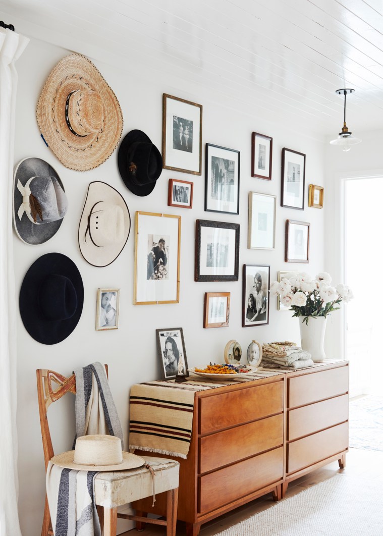 a-collection-of-hats-and-art-surround-the-dresser-in-the-bedroom-relaxed-ranch-house-tour-on-coco-kelley